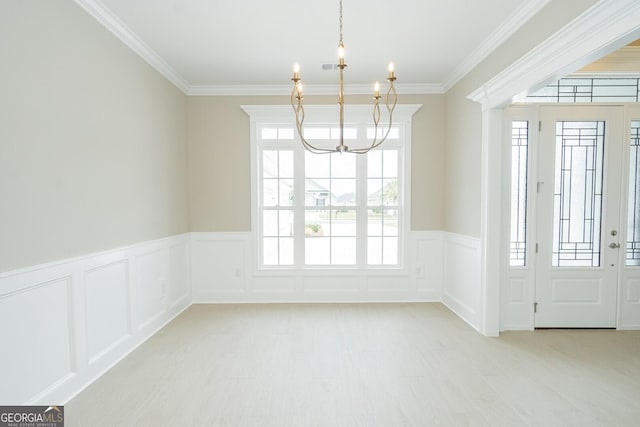 215 Jake Colton Dr, Kingsland, GA 31548 - unfurnished dining area featuring a chandelier, ornamental molding, a decorative wall, wainscoting, and wood finished floors
