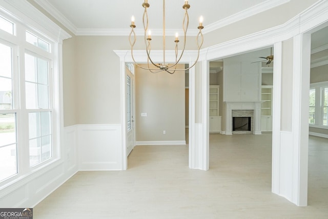 215 Jake Colton Dr, Kingsland, GA 31548 - empty room featuring a chandelier, crown molding, light wood-style flooring, a ceiling fan, and a fireplace