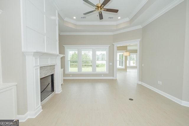 215 Jake Colton Dr, Kingsland, GA 31548 - unfurnished living room featuring a ceiling fan, a high end fireplace, light wood finished floors, plenty of natural light, and crown molding