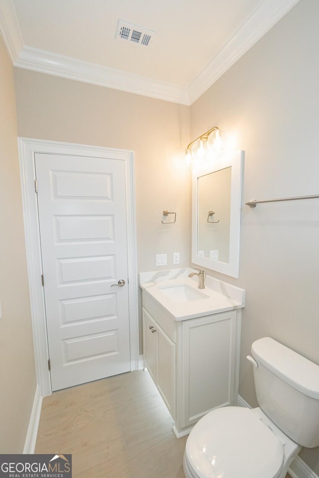 215 Jake Colton Dr, Kingsland, GA 31548 - half bath featuring crown molding, vanity, toilet, and wood finished floors