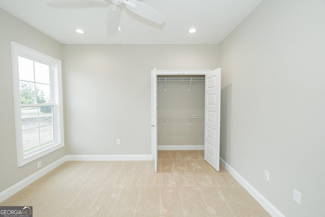 215 Jake Colton Dr, Kingsland, GA 31548 - unfurnished bedroom with light colored carpet, a closet, baseboards, recessed lighting, and ceiling fan