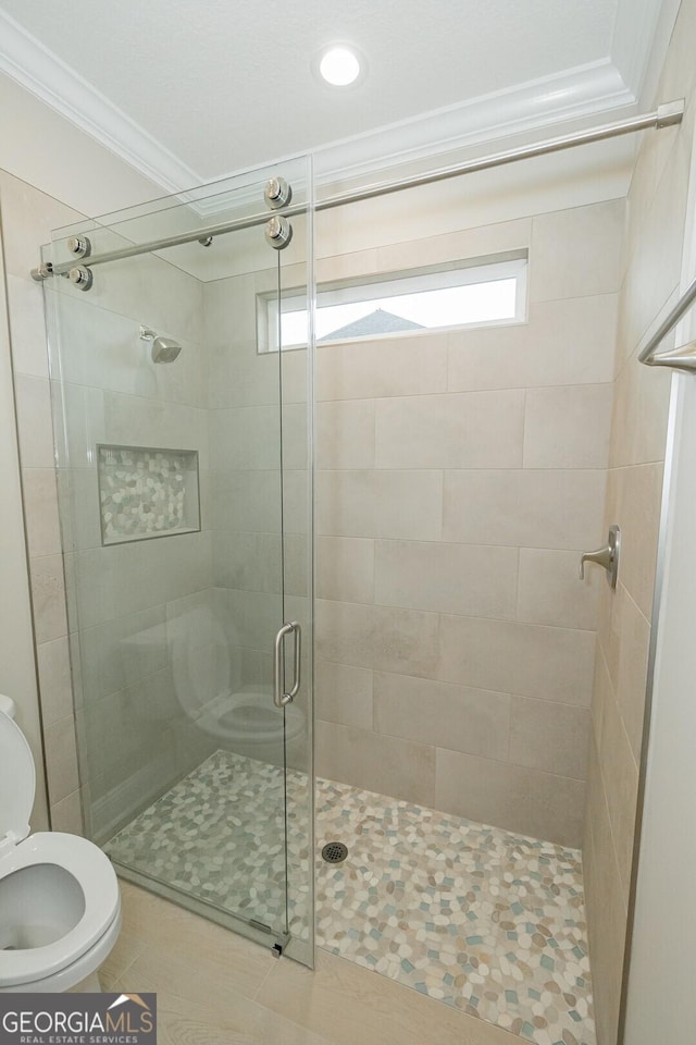 215 Jake Colton Dr, Kingsland, GA 31548 - bathroom featuring toilet, ornamental molding, and a stall shower
