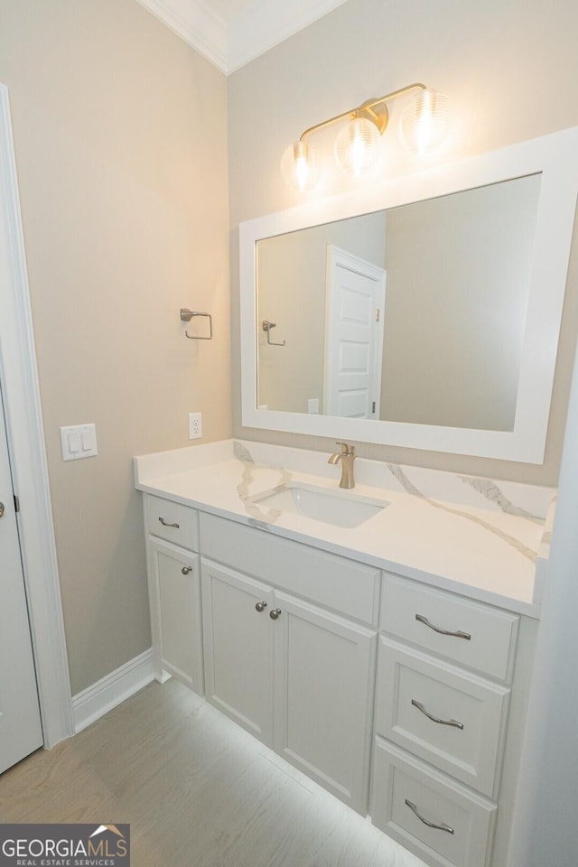 215 Jake Colton Dr, Kingsland, GA 31548 - bathroom with vanity, ornamental molding, wood finished floors, and baseboards