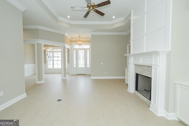 215 Jake Colton Dr, Kingsland, GA 31548 - unfurnished living room featuring a ceiling fan, a fireplace, a chandelier, light wood-type flooring, and crown molding