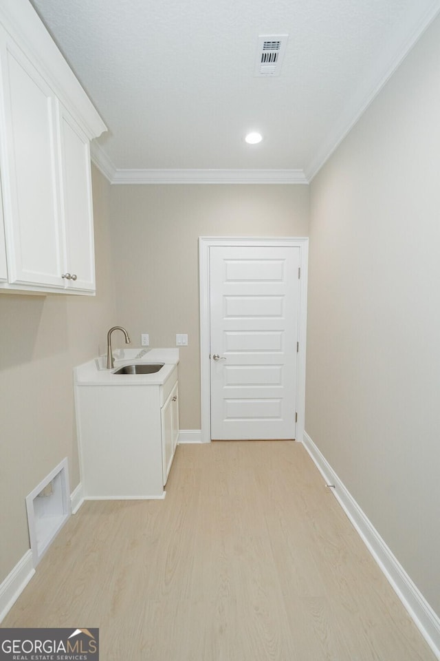 215 Jake Colton Dr, Kingsland, GA 31548 - laundry area featuring cabinet space, ornamental molding, light wood-style floors, baseboards, and recessed lighting