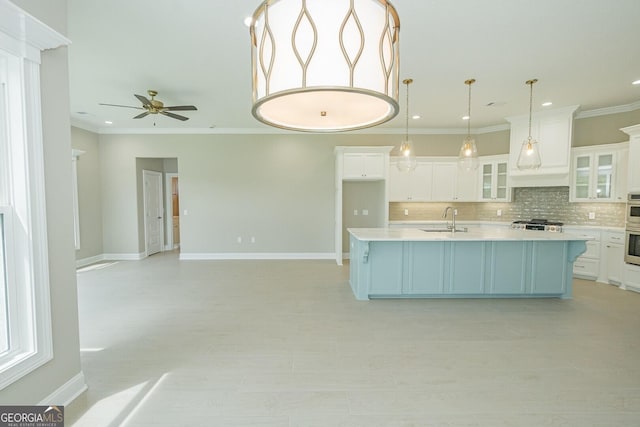 215 Jake Colton Dr, Kingsland, GA 31548 - kitchen featuring a sink, backsplash, light countertops, ornamental molding, and white cabinets