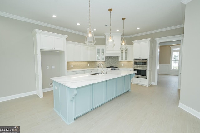 215 Jake Colton Dr, Kingsland, GA 31548 - kitchen featuring a sink, double oven, backsplash, white cabinets, and crown molding