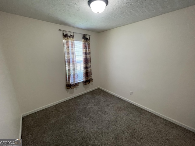 401 Bainbridge Dr, Mcdonough, GA 30253 - spare room with carpet flooring, a textured ceiling, and baseboards