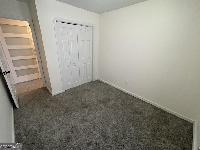 401 Bainbridge Dr, Mcdonough, GA 30253 - unfurnished bedroom featuring carpet flooring, baseboards, and a closet