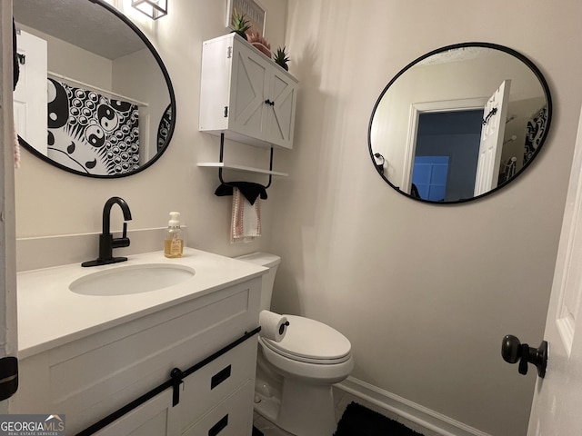401 Bainbridge Dr, Mcdonough, GA 30253 - bathroom featuring toilet, vanity, and baseboards