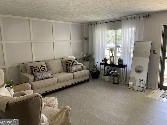 401 Bainbridge Dr, Mcdonough, GA 30253 - living area with a decorative wall and a textured ceiling