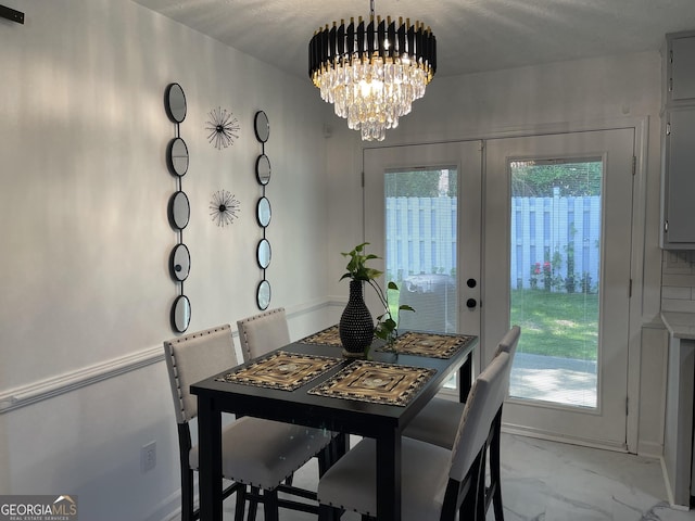 401 Bainbridge Dr, Mcdonough, GA 30253 - dining space featuring a chandelier, marble look tiles, and french doors