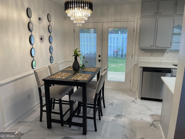 401 Bainbridge Dr, Mcdonough, GA 30253 - dining space featuring light marble finish floors, a chandelier, french doors, and baseboards