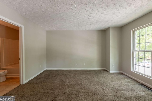 1851 Grove Way, Hampton, GA 30228 - carpeted empty room with baseboards and a textured ceiling