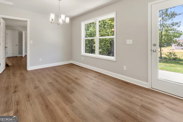 68 Davis Lake Rd Lot 16, Thomaston, GA 30286 - unfurnished dining area featuring a chandelier, baseboards, and light wood-style flooring