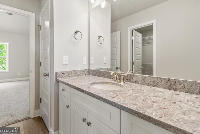 68 Davis Lake Rd Lot 16, Thomaston, GA 30286 - bathroom featuring vanity, wood finished floors, baseboards, and a walk in closet