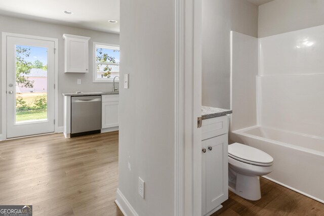 68 Davis Lake Rd Lot 16, Thomaston, GA 30286 - bathroom featuring vanity, toilet, wood finished floors, and washtub / shower combination