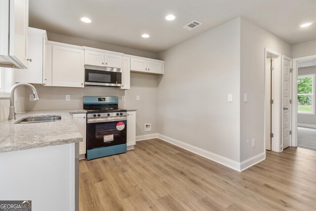 68 Davis Lake Rd Lot 16, Thomaston, GA 30286 - kitchen featuring appliances with stainless steel finishes, a sink, light wood-type flooring, white cabinets, and recessed lighting