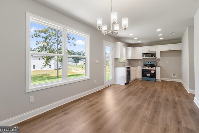 68 Davis Lake Rd Lot 16, Thomaston, GA 30286 - kitchen with stainless steel appliances, a chandelier, light wood-type flooring, white cabinets, and plenty of natural light