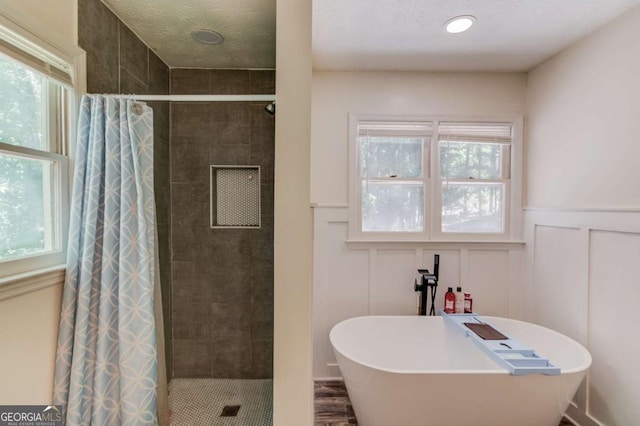 2020 Commonwealth Pl, Cumming, GA 30041 - full bathroom with a shower stall, a decorative wall, plenty of natural light, a freestanding tub, and a wainscoted wall