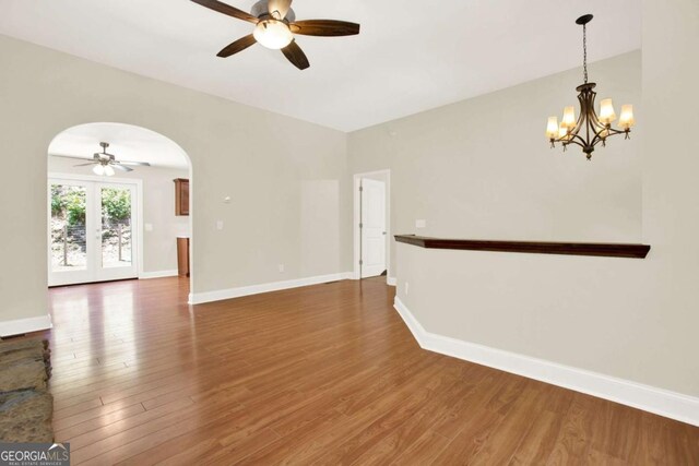 405 Scenic View Dr, Jasper, GA 30143 - spare room with ceiling fan, arched walkways, wood finished floors, and a chandelier
