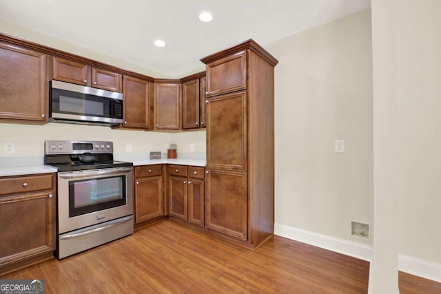 405 Scenic View Dr, Jasper, GA 30143 - kitchen featuring appliances with stainless steel finishes, light countertops, baseboards, light wood-style flooring, and recessed lighting