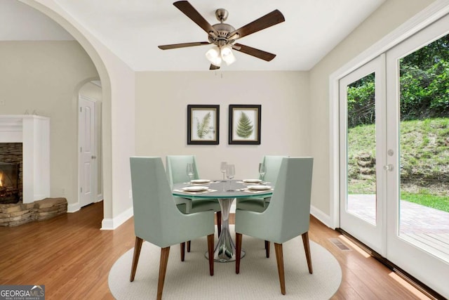 405 Scenic View Dr, Jasper, GA 30143 - dining room with light wood-type flooring, baseboards, arched walkways, and a ceiling fan