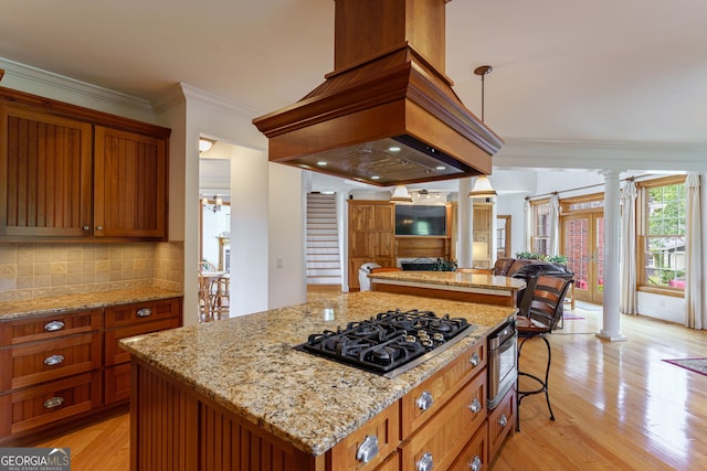 4320 Sandy Creek Rd, Madison, GA 30650 - kitchen with ornate columns, black gas stovetop, ornamental molding, and brown cabinets