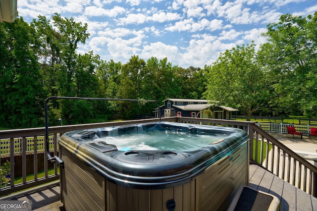 4320 Sandy Creek Rd, Madison, GA 30650 - wooden deck featuring a hot tub and view of scattered trees