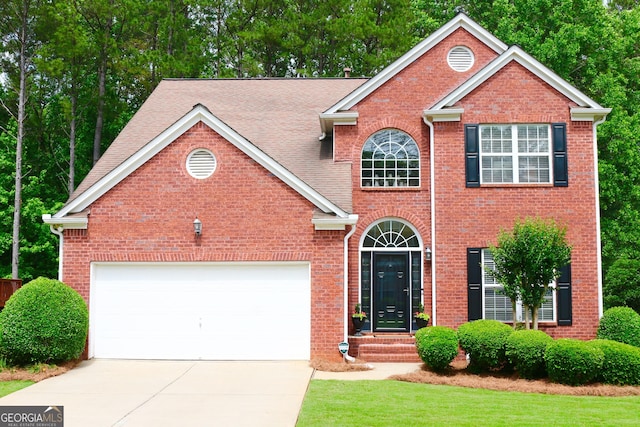 318 Ivy Manor Dr, Marietta, GA 30064 - view of front of home with driveway, brick siding, an attached garage, and a front yard