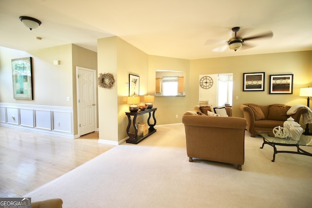 318 Ivy Manor Dr, Marietta, GA 30064 - living room with ceiling fan, carpet flooring, wood finished floors, wainscoting, and baseboards