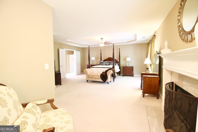 318 Ivy Manor Dr, Marietta, GA 30064 - bedroom featuring a tile fireplace, a tray ceiling, carpet floors, and baseboards