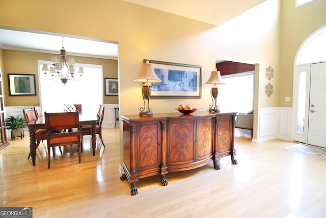 318 Ivy Manor Dr, Marietta, GA 30064 - foyer entrance with a chandelier, light wood-type flooring, wainscoting, and a decorative wall