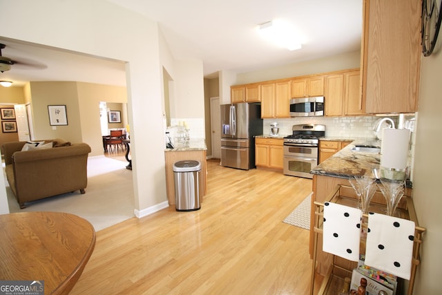 318 Ivy Manor Dr, Marietta, GA 30064 - kitchen featuring appliances with stainless steel finishes, light brown cabinetry, light wood-type flooring, tasteful backsplash, and a sink