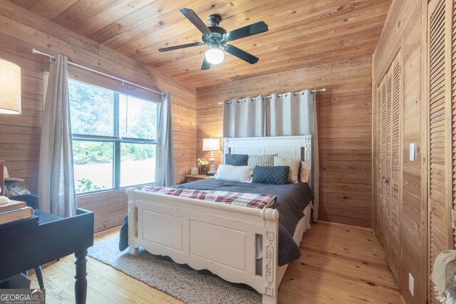 912 Folds Rd, Carrollton, GA 30116 - bedroom with wood walls, light wood finished floors, wooden ceiling, and a ceiling fan