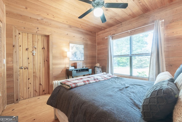 912 Folds Rd, Carrollton, GA 30116 - bedroom featuring light wood-style floors, wood walls, and ceiling fan