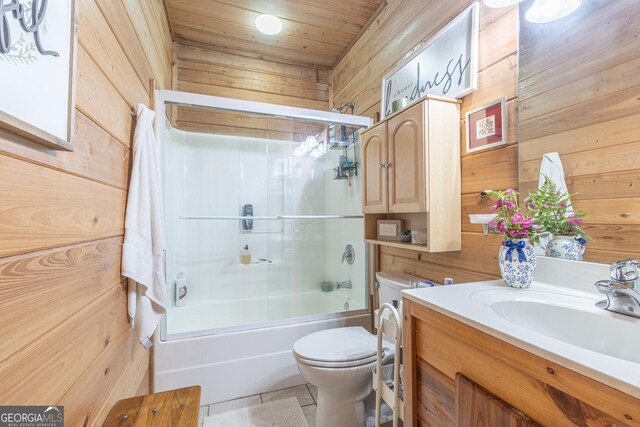 912 Folds Rd, Carrollton, GA 30116 - bathroom with wood walls, toilet, vanity, bath / shower combo with glass door, and wooden ceiling