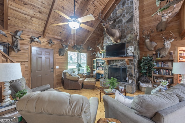 912 Folds Rd, Carrollton, GA 30116 - living room with wood walls, wood ceiling with exposed beams, wood finished floors, high vaulted ceiling, and a fireplace
