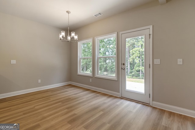 215 Davis Lake Ct Lot 2, Thomaston, GA 30286 - unfurnished dining area featuring plenty of natural light, light wood-style flooring, baseboards, and a chandelier