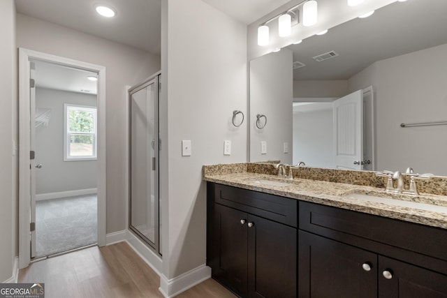 215 Davis Lake Ct Lot 2, Thomaston, GA 30286 - full bath with wood finished floors, double vanity, a stall shower, and baseboards
