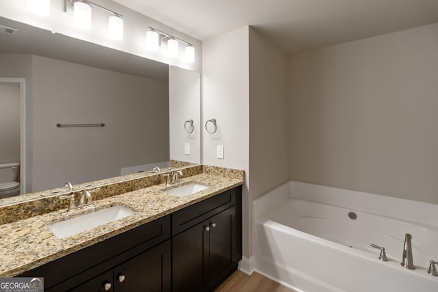 215 Davis Lake Ct Lot 2, Thomaston, GA 30286 - full bathroom with double vanity, a bath, wood finished floors, and toilet