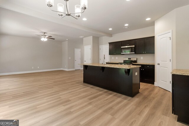 215 Davis Lake Ct Lot 2, Thomaston, GA 30286 - kitchen featuring stainless steel appliances, light wood finished floors, a kitchen bar, a ceiling fan, and decorative light fixtures