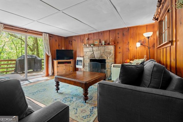 8378 Dillard Rd, Scaly, NC 28775 - living area featuring wood walls, heating unit, a fireplace, and wood finished floors