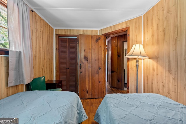 8378 Dillard Rd, Scaly, NC 28775 - bedroom featuring wooden walls, wood finished floors, crown molding, and a closet