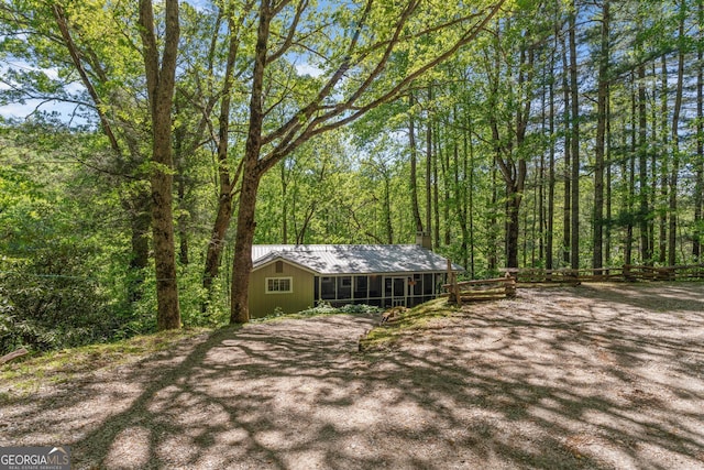 8378 Dillard Rd, Scaly, NC 28775 - view of front of home with a chimney, metal roof, a wooded view, and a sunroom