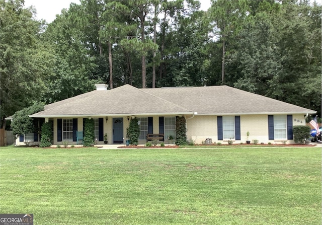 281 Cambridge Cir, Kingsland, GA 31548 - single story home with a porch, a front yard, a chimney, and roof with shingles
