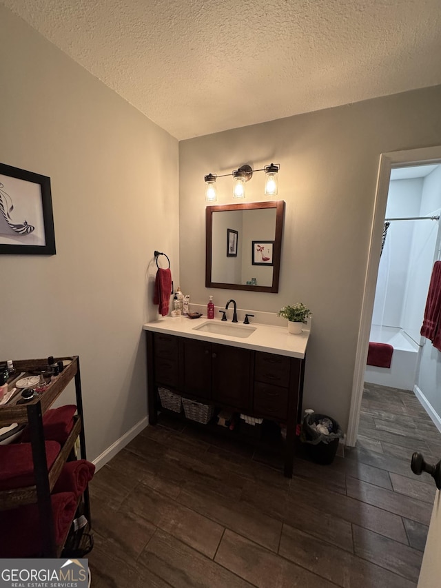 281 Cambridge Cir, Kingsland, GA 31548 - full bath with vanity, wood finished floors, a textured ceiling, and shower / bath combo