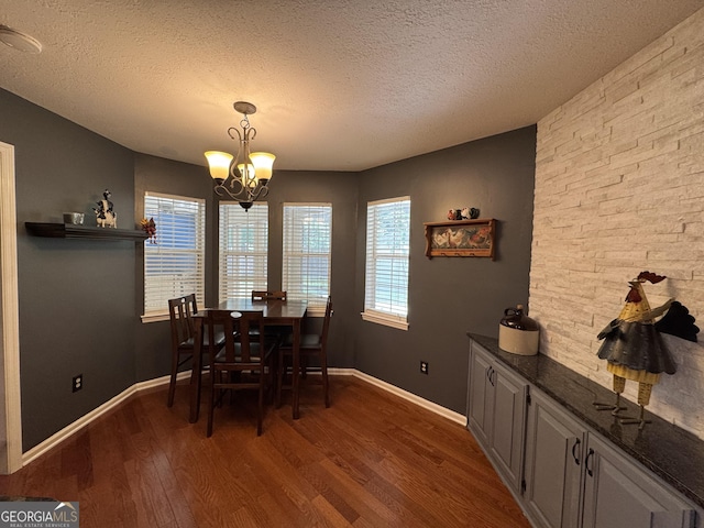 281 Cambridge Cir, Kingsland, GA 31548 - dining space with a chandelier, dark wood-style floors, and a textured ceiling