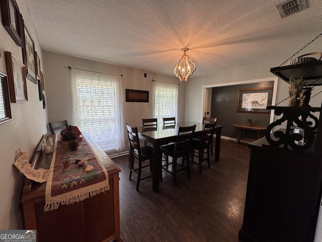 281 Cambridge Cir, Kingsland, GA 31548 - dining area with a textured ceiling, a chandelier, and dark wood-type flooring