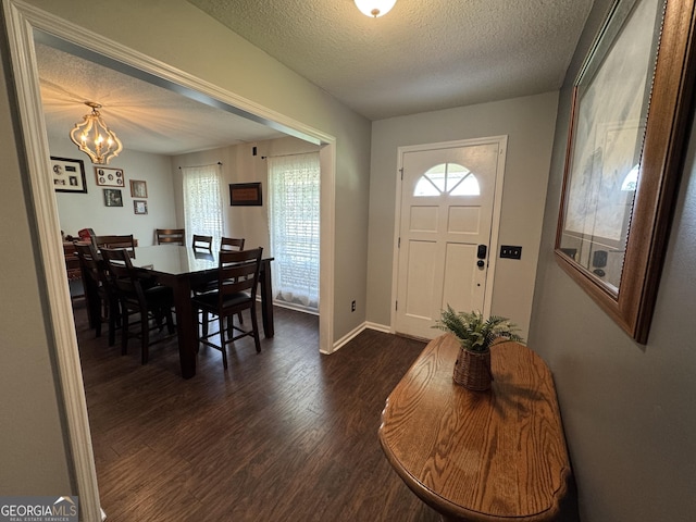 281 Cambridge Cir, Kingsland, GA 31548 - foyer with dark wood-type flooring, a chandelier, and a textured ceiling